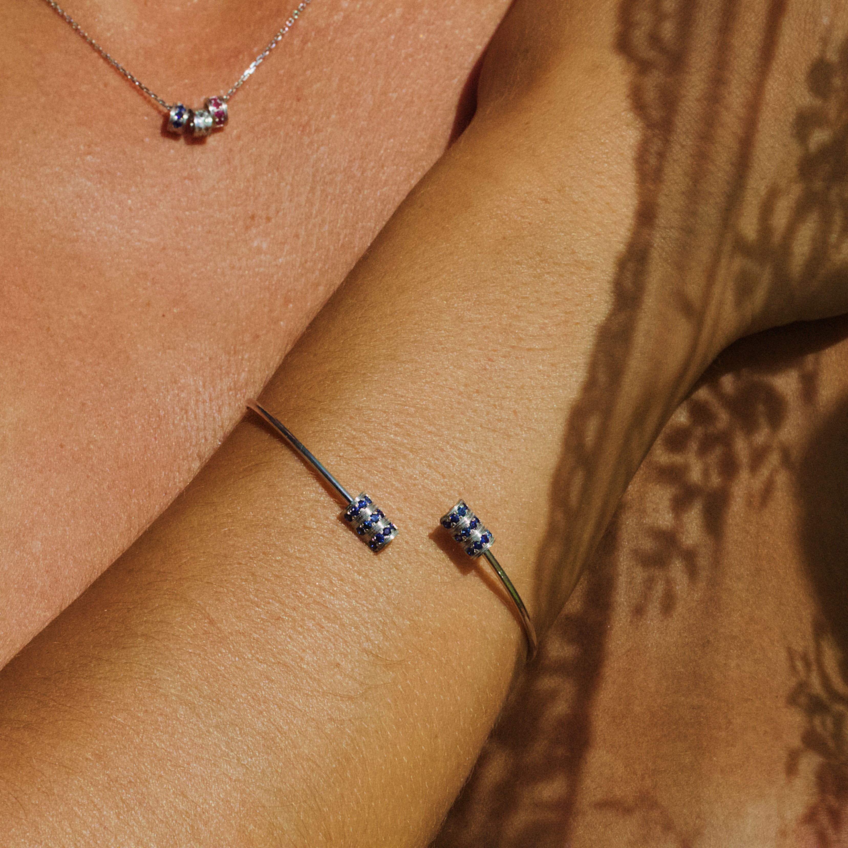 The "Gram" open bangle bracelet, White Gold and blue sapphires